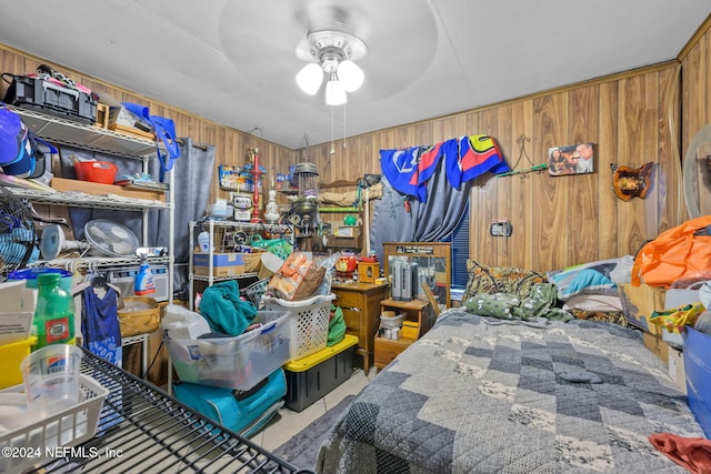 bedroom with wooden walls and ceiling fan