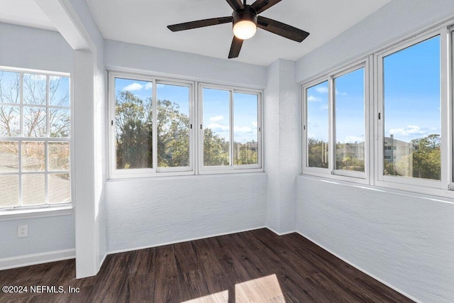 unfurnished sunroom with ceiling fan