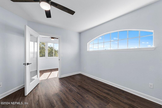 unfurnished room with dark hardwood / wood-style floors, a healthy amount of sunlight, ceiling fan, and french doors