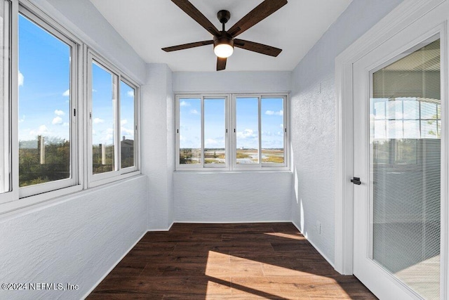 unfurnished sunroom with ceiling fan