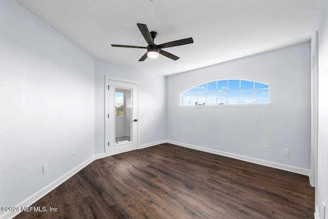 empty room featuring ceiling fan and dark wood-type flooring