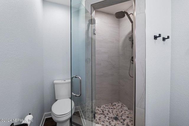 bathroom featuring toilet and walk in shower