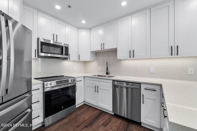 kitchen featuring white cabinetry, dark hardwood / wood-style flooring, sink, and appliances with stainless steel finishes