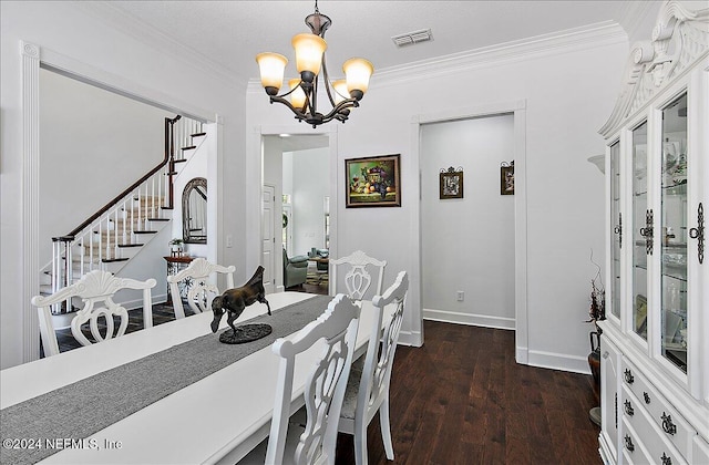 dining space featuring dark hardwood / wood-style floors, a chandelier, and ornamental molding