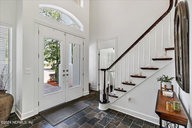 entrance foyer with a high ceiling and french doors