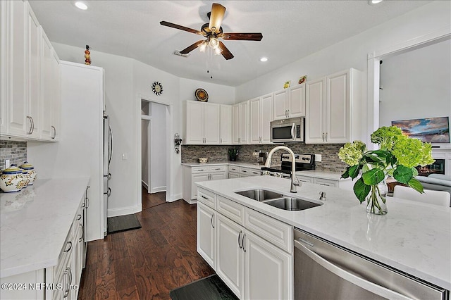 kitchen featuring dark hardwood / wood-style flooring, appliances with stainless steel finishes, sink, and white cabinets