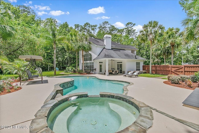 view of pool with an in ground hot tub and a patio area