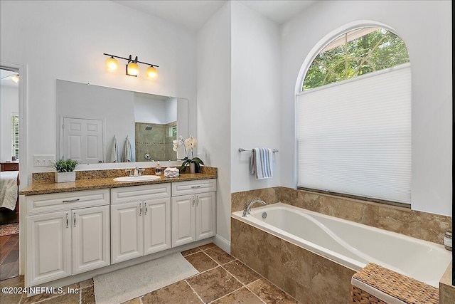 bathroom featuring vanity and plus walk in shower