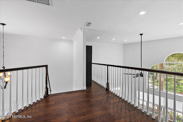 hallway featuring dark hardwood / wood-style floors and a textured ceiling