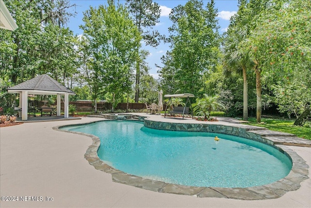 view of swimming pool featuring a patio and a gazebo