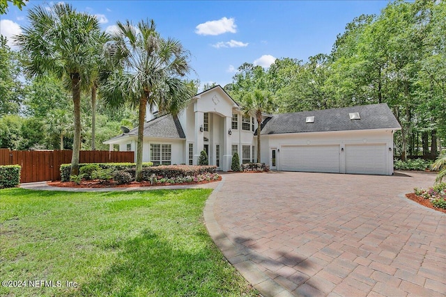 view of front of house with a garage and a front yard