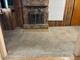 unfurnished living room with a stone fireplace