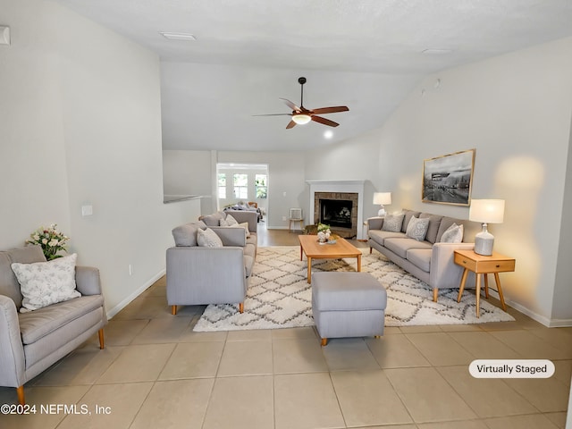 tiled living room featuring ceiling fan and lofted ceiling