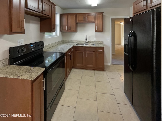 5225 Royce Ave, Jacksonville, FL 32205 - kitchen with black appliances, a sink, light tile patterned flooring, and light stone countertops