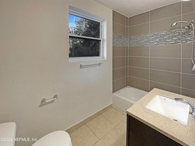 full bathroom with tile patterned floors, vanity, toilet, and tiled shower / bath combo