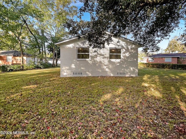 view of side of home featuring a yard