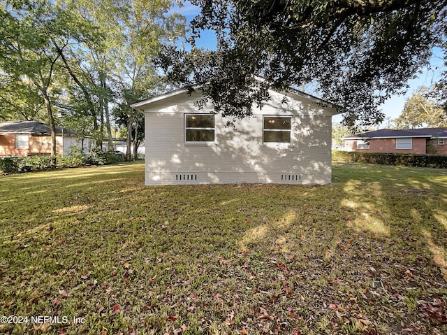 5225 Royce Ave, Jacksonville, FL 32205 - view of side of home with crawl space, a yard, and brick siding