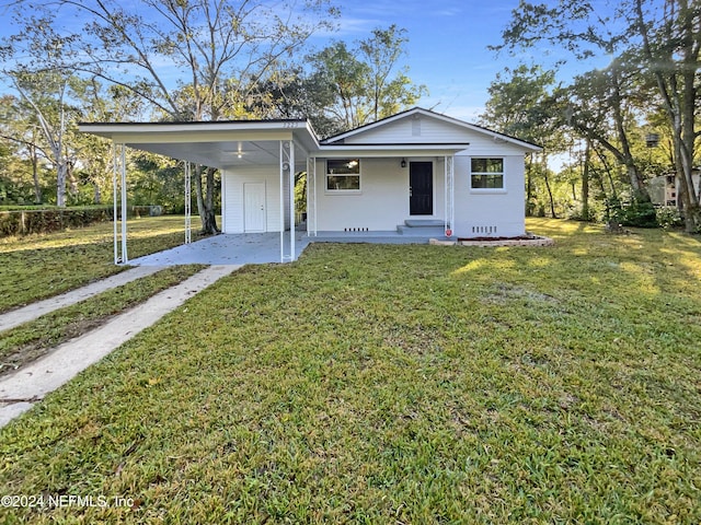 5225 Royce Ave, Jacksonville, FL 32205 - view of front facade featuring driveway, an attached carport, a front lawn, and a porch