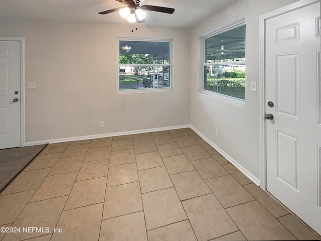 tiled entrance foyer with ceiling fan