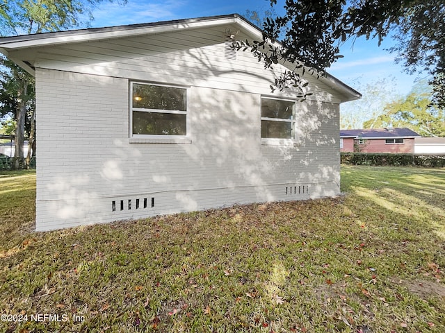 view of property exterior with a yard