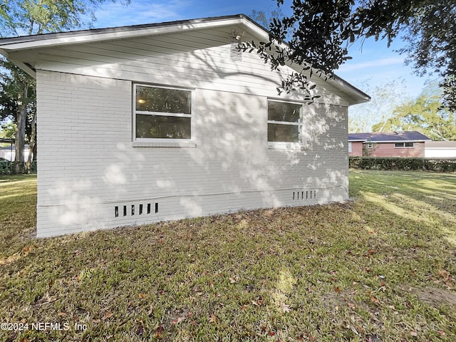 5225 Royce Ave, Jacksonville, FL 32205 - view of side of home featuring crawl space, brick siding, and a lawn