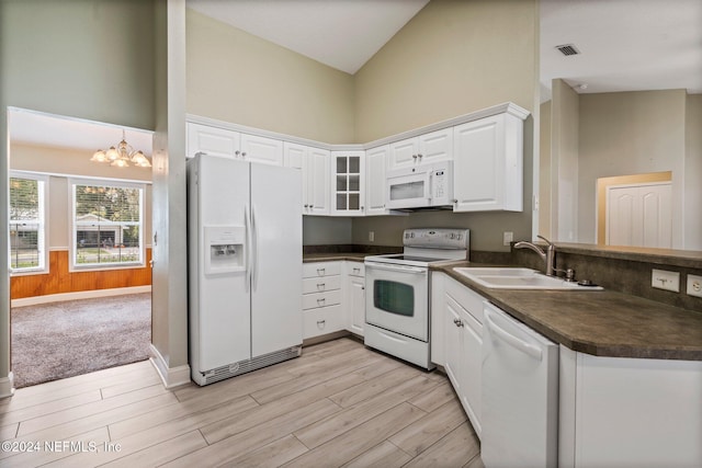 kitchen with white cabinetry, light hardwood / wood-style flooring, sink, and white appliances