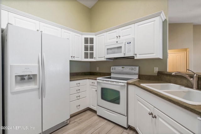 kitchen with white cabinets, white appliances, sink, and light hardwood / wood-style flooring