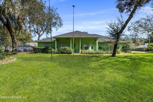 exterior space with a yard and ceiling fan