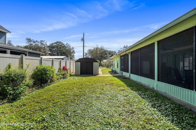 view of yard featuring a storage unit and a sunroom