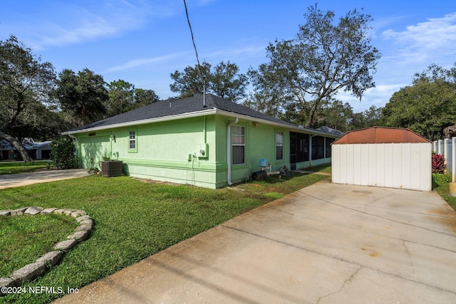 view of side of property featuring a yard and cooling unit