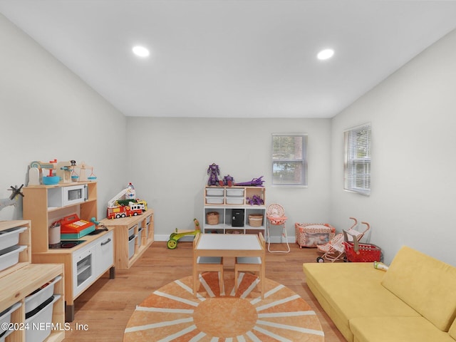 playroom with light hardwood / wood-style flooring