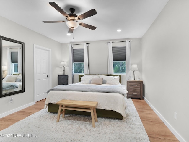 bedroom featuring light wood-type flooring and ceiling fan