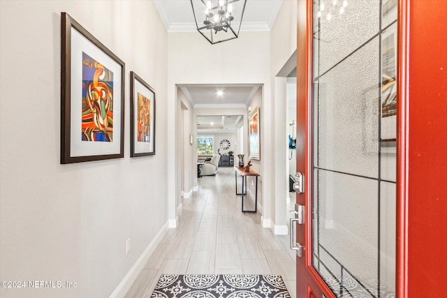 corridor featuring an inviting chandelier and crown molding