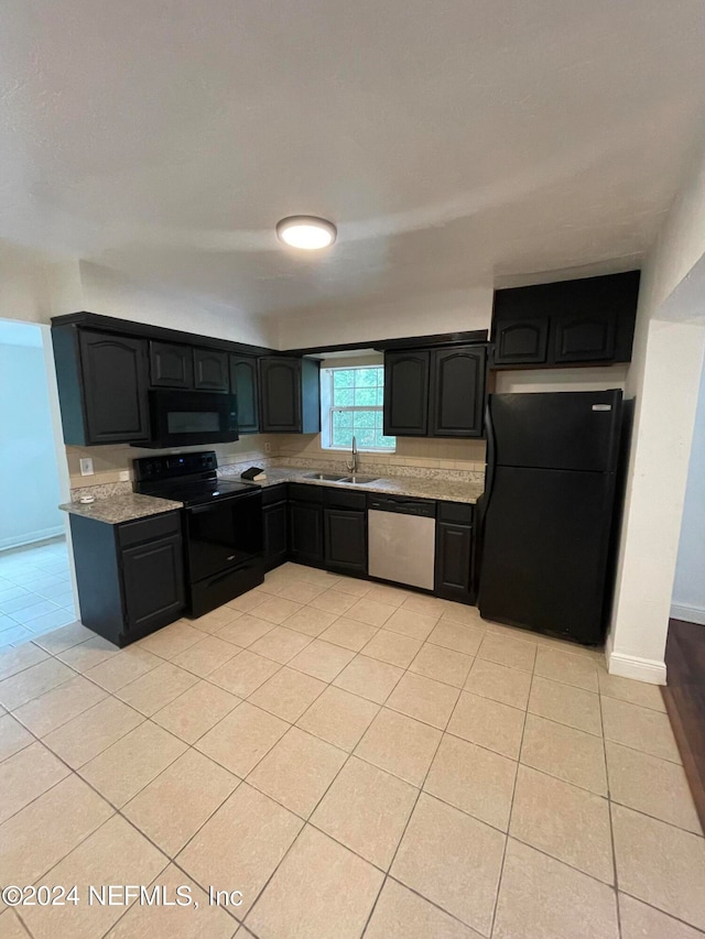 kitchen featuring black appliances, sink, and light tile patterned floors