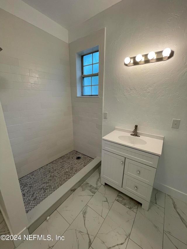 bathroom featuring vanity and tiled shower