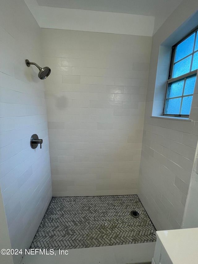 bathroom with a tile shower