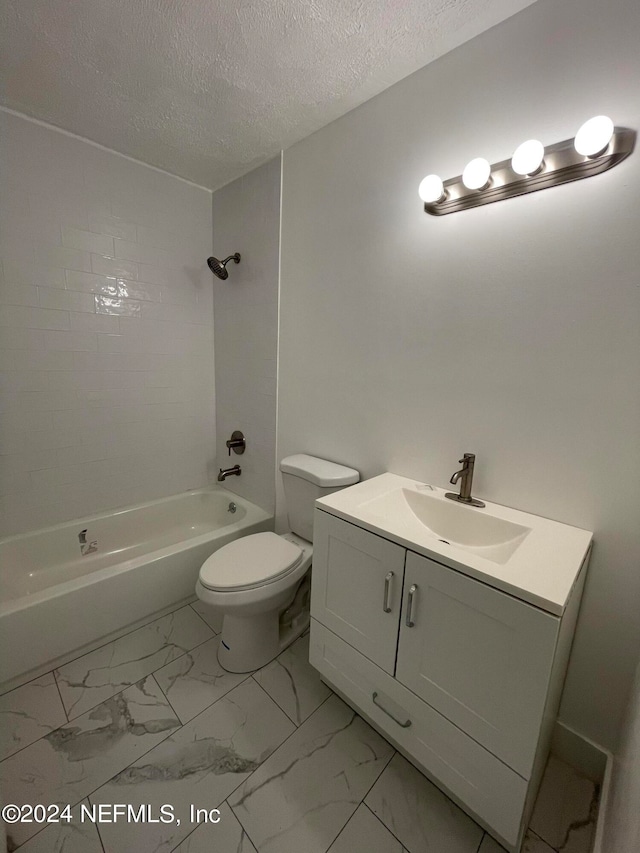 full bathroom with toilet, tiled shower / bath combo, vanity, and a textured ceiling