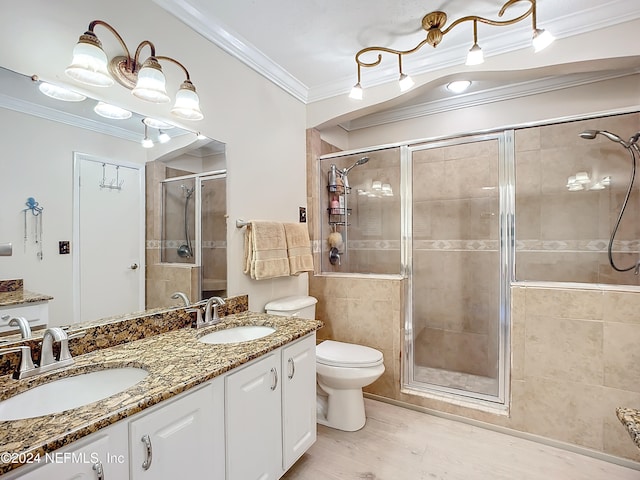 bathroom with walk in shower, wood-type flooring, vanity, crown molding, and toilet