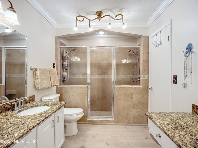 bathroom with walk in shower, wood-type flooring, vanity, crown molding, and toilet