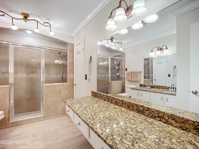 bathroom with walk in shower, toilet, hardwood / wood-style flooring, and ornamental molding