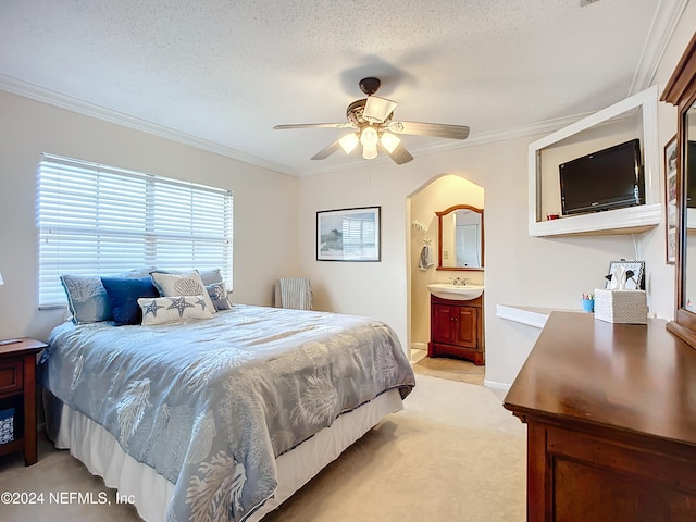 bedroom with ensuite bathroom, a textured ceiling, ceiling fan, and crown molding