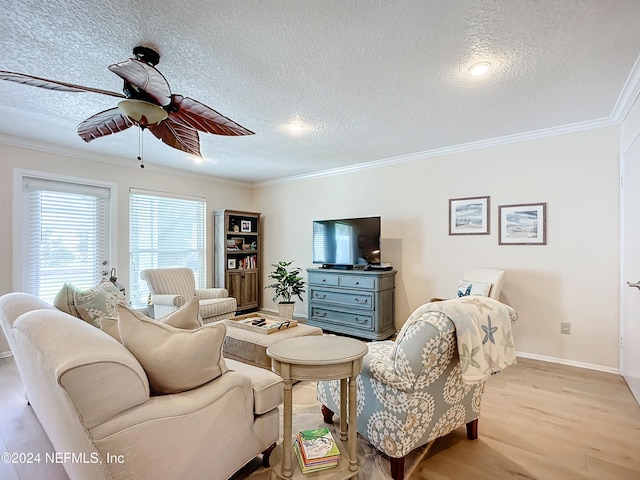 living room featuring light wood-type flooring, a textured ceiling, and ornamental molding