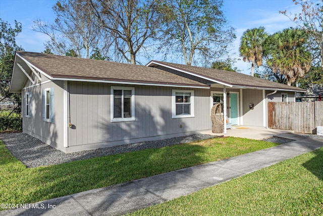 ranch-style home with a front lawn