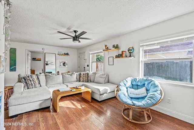 living room featuring a textured ceiling, hardwood / wood-style flooring, and ceiling fan