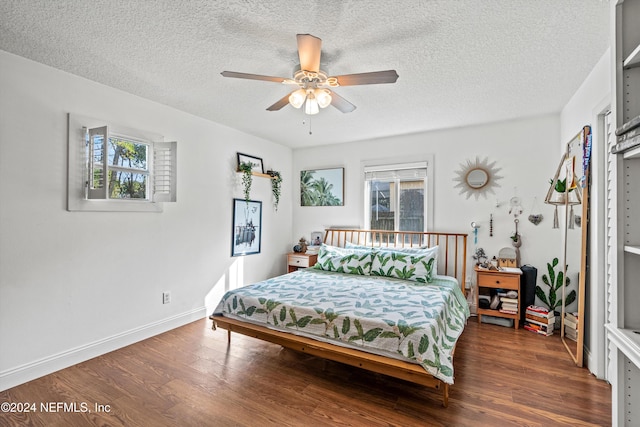 bedroom with dark hardwood / wood-style flooring, a textured ceiling, and ceiling fan