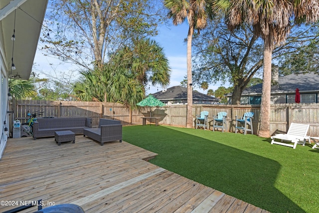 wooden terrace with a lawn and outdoor lounge area