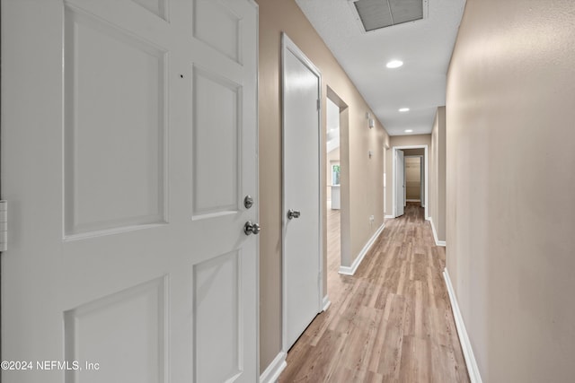 hallway with light hardwood / wood-style flooring