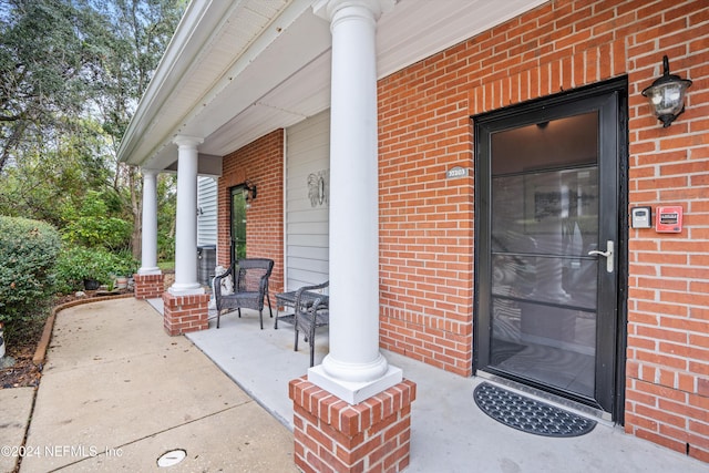 view of exterior entry with a porch