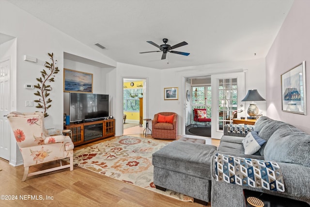 living room featuring hardwood / wood-style floors, vaulted ceiling, and ceiling fan