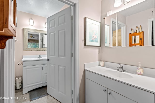 bathroom featuring tile patterned floors, vanity, and a textured ceiling